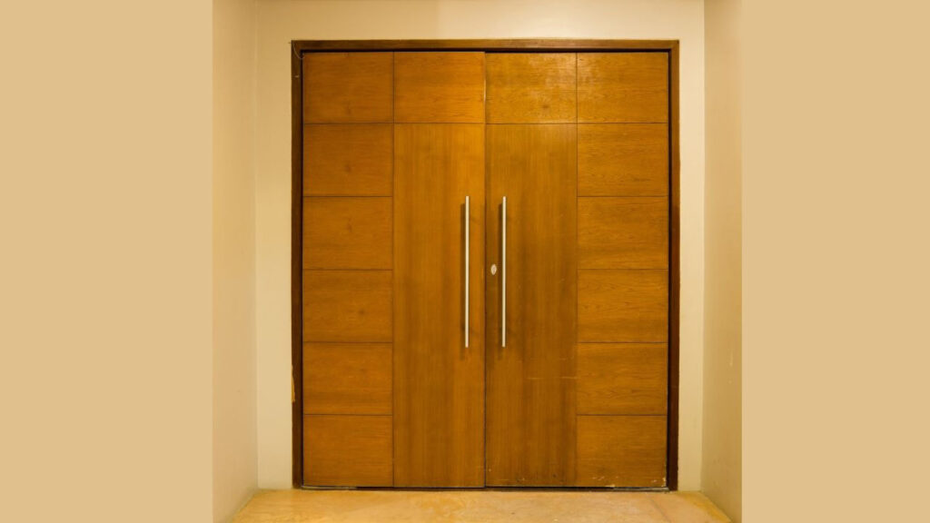 a full-sized wooden flush door with metal handles