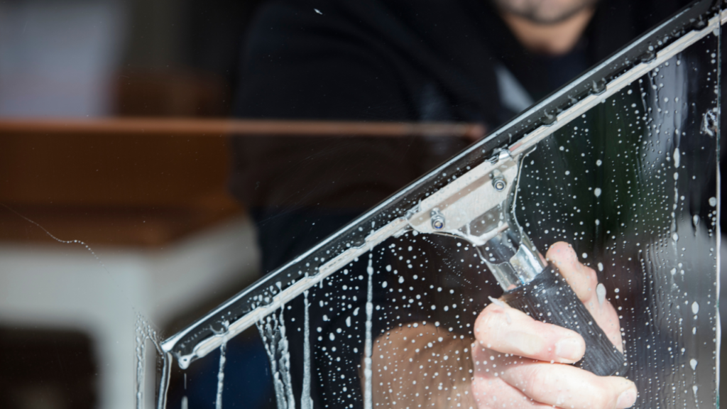 A person cleaning a window