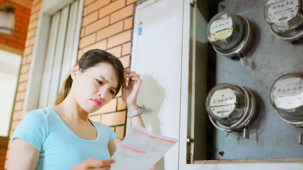 A woman looking at energy bills worried about home's energy efficiency