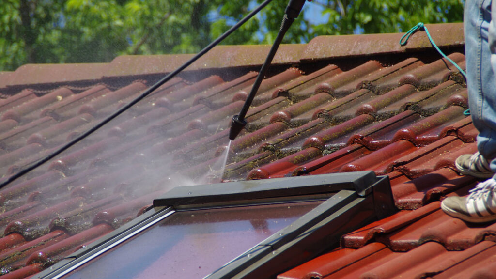 Cleaning a window with sticky materials using a pressure wash equipment